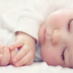 sleeping baby long eyelashes in white