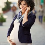 happy pregnant woman talking on the phone